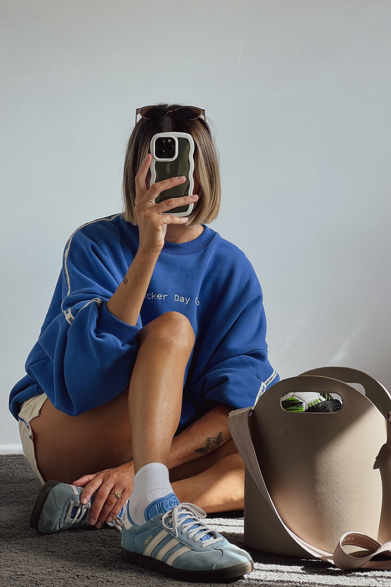 cloud racer sweater in blue with cracker day club embroidery on the sleeve