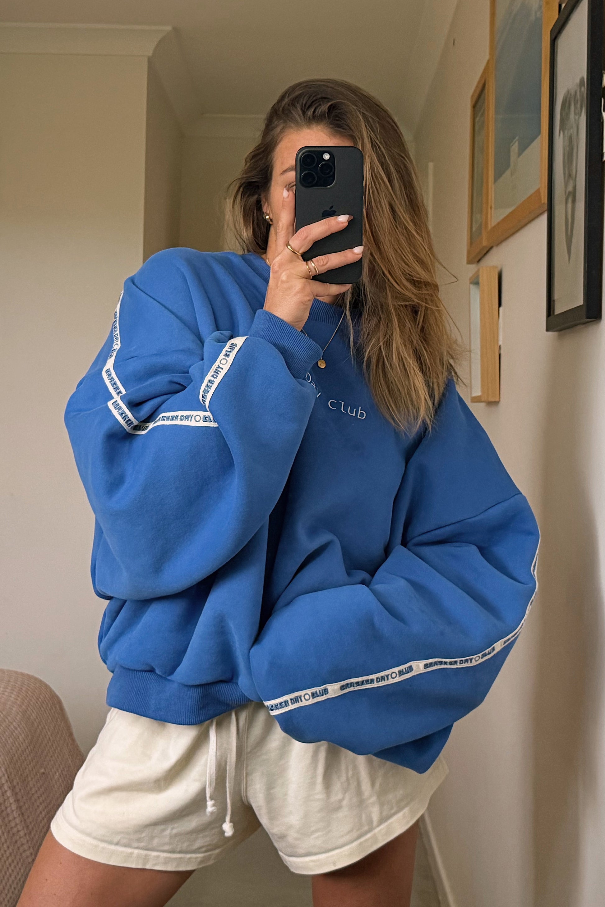 cloud racer sweater in blue with cracker day club embroidery on the sleeve