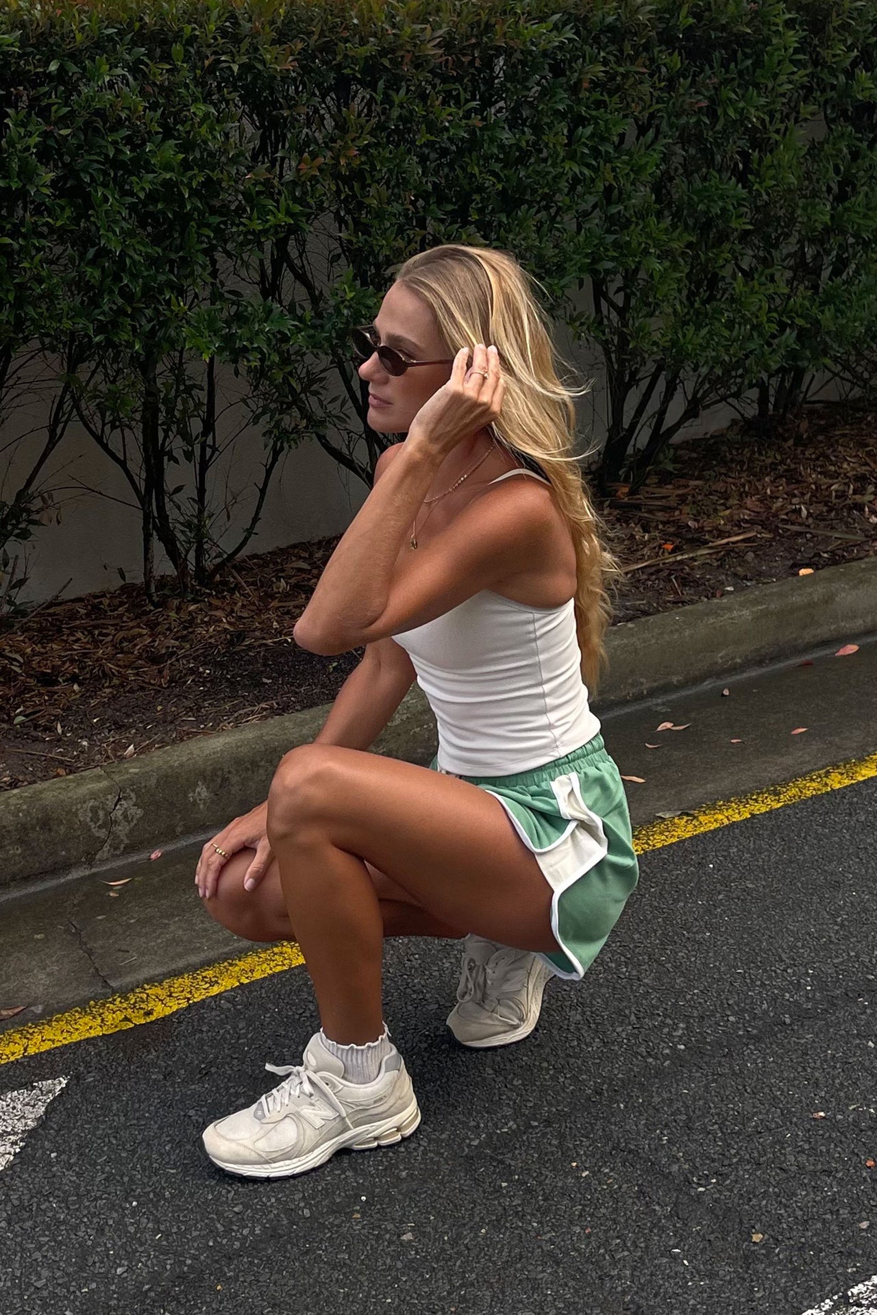 girl wearing streetwear cracker day club retro green shorts with white stripe