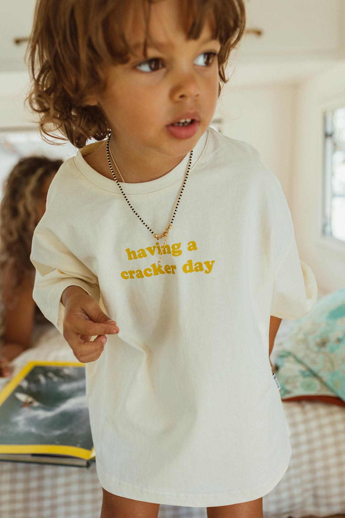 cracker day club tshirt in butter with slogan having a cracker day in mustard