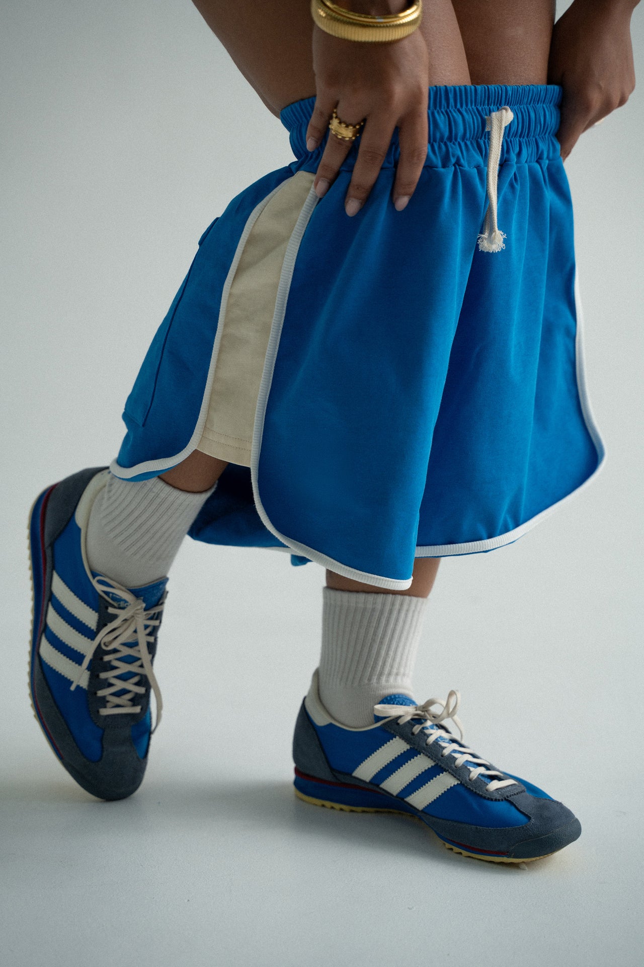 blue retro shorts by cracker day club worn by a women with blue adidas shoes