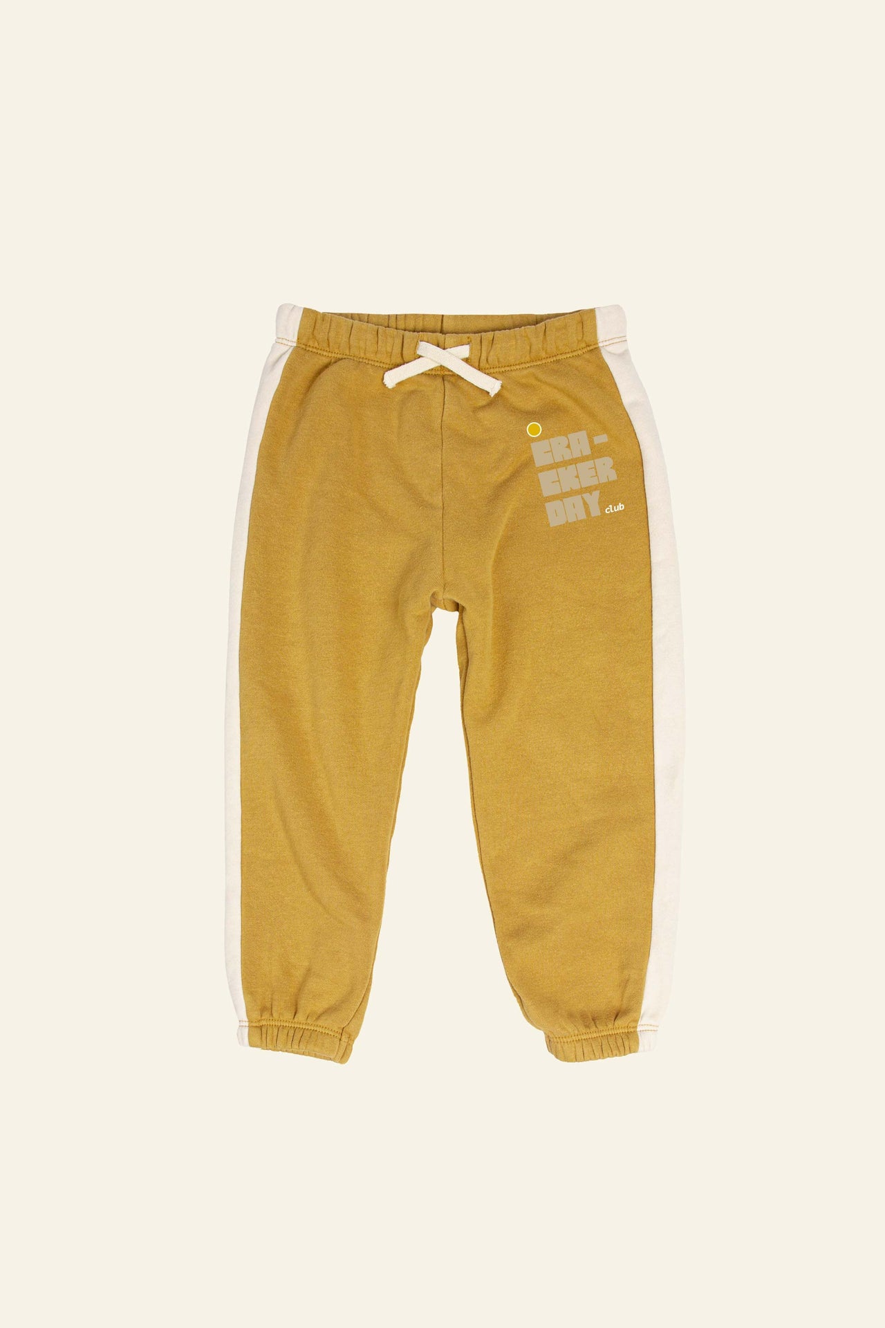 The Little Stacked Retro Sweatpants in mustard and butter feature a retro stripe design