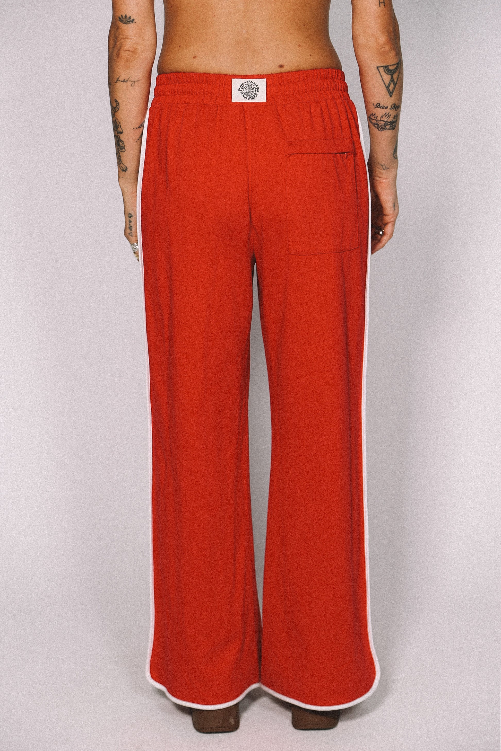 Red pants worn by a person on a white background