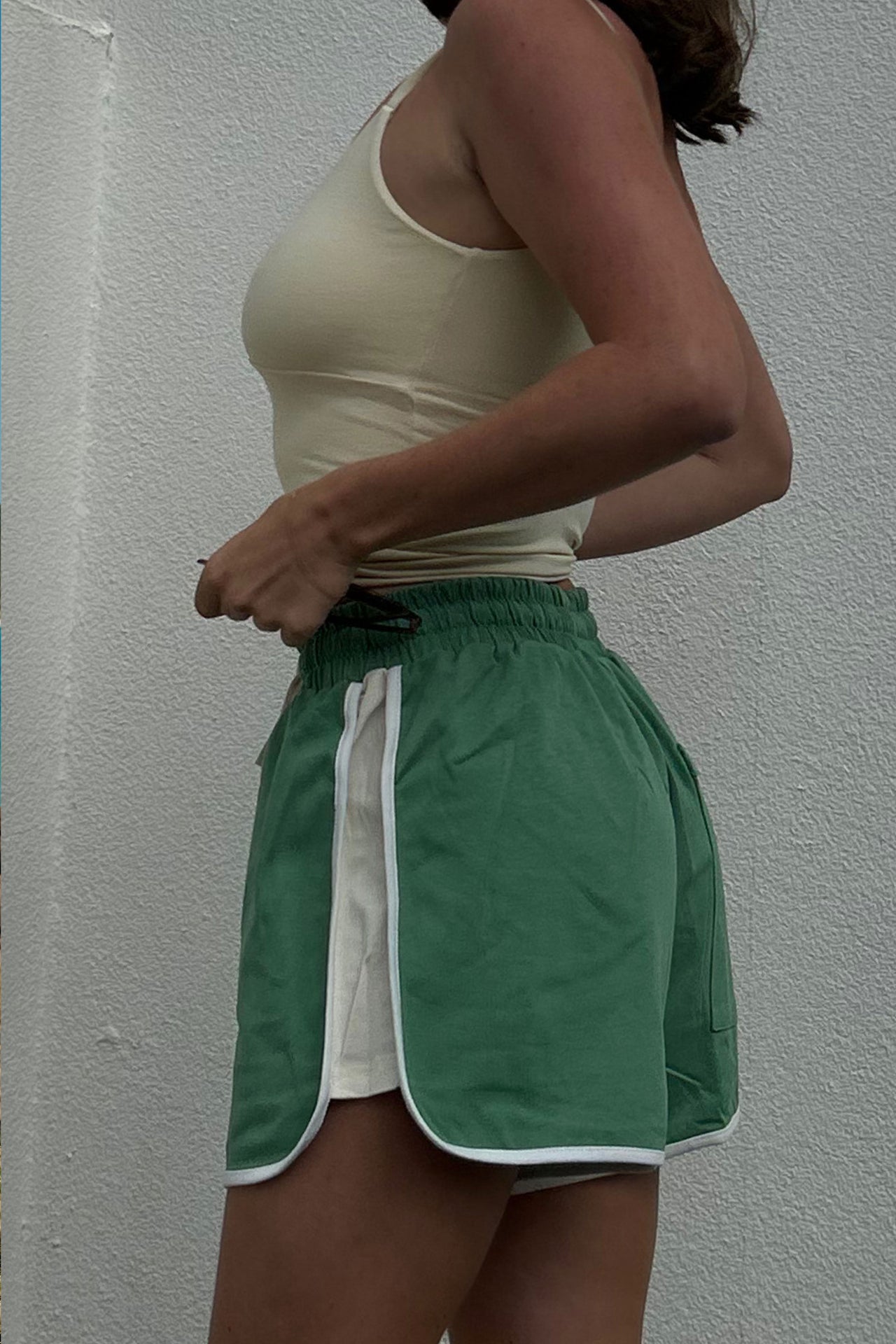 girl wearing streetwear cracker day club retro green shorts with white stripe