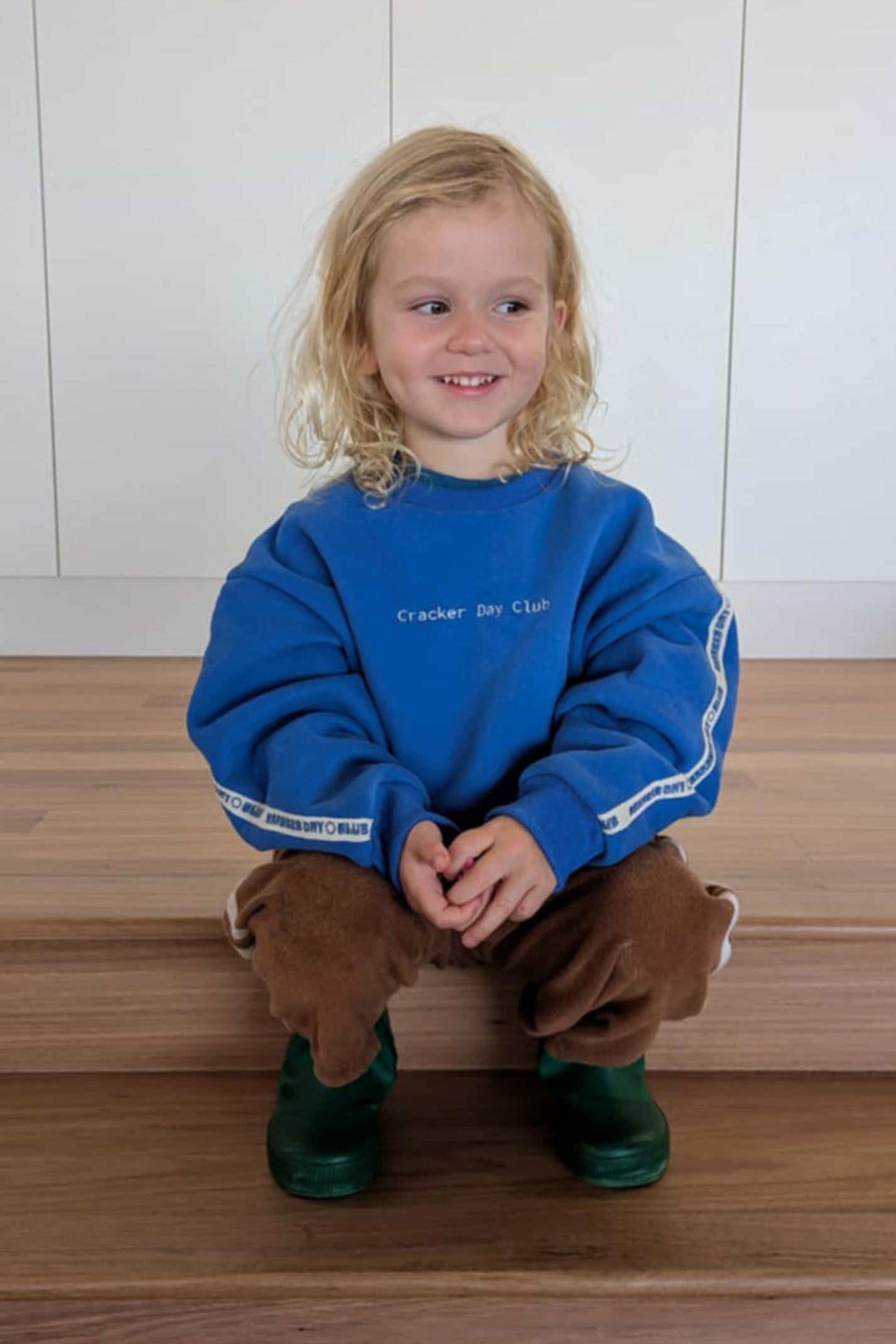 little boy wearing a blue oversized sweater by cracker day club