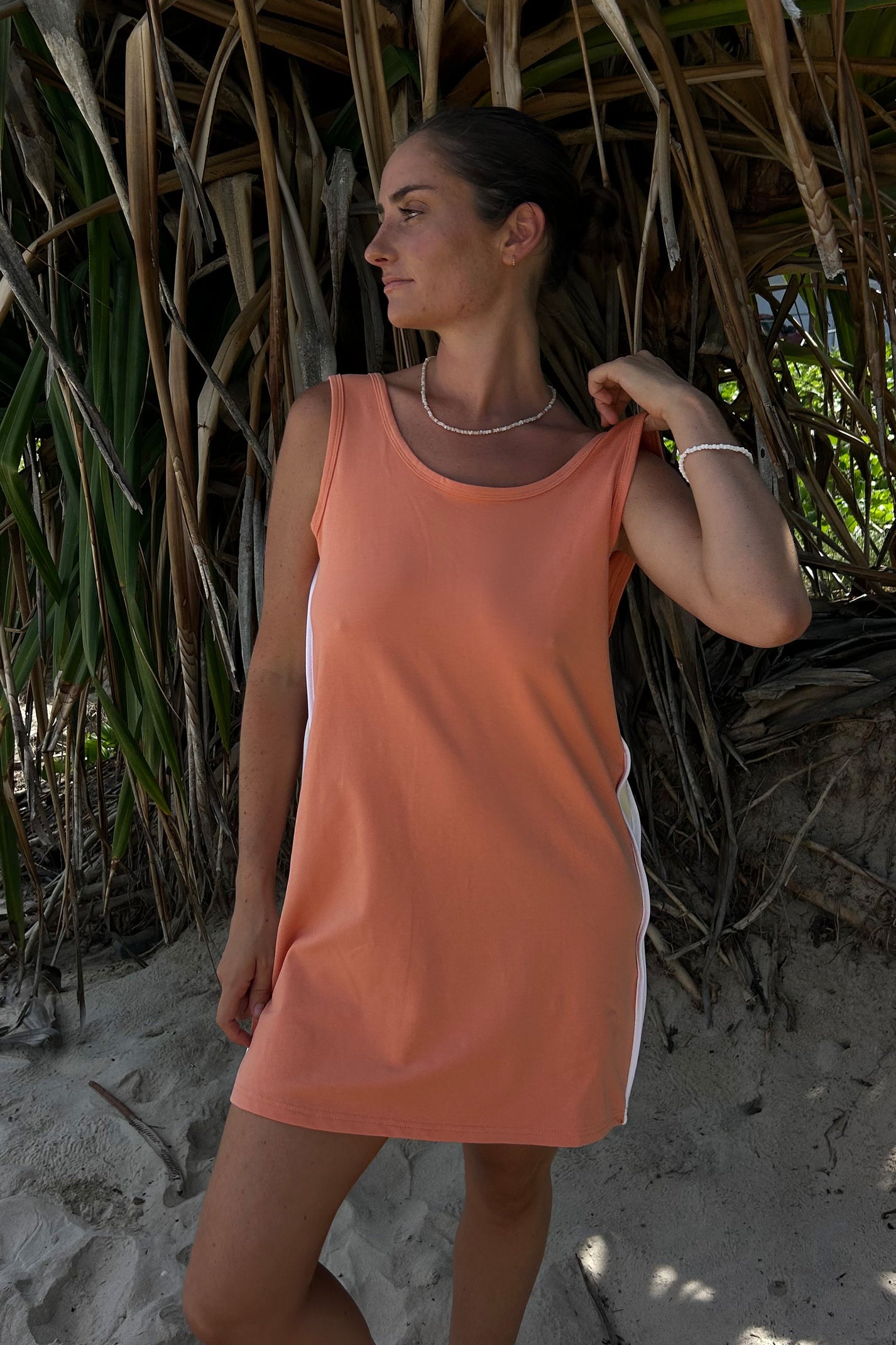woman ojn the beach in an orange cracker day club retro dress
